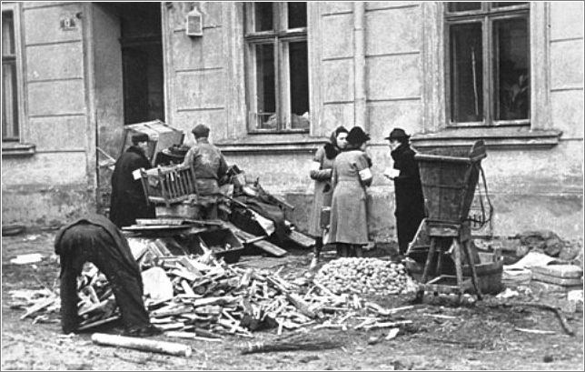 A group of Jews chop up furniture to use as fuel in the Krakow ghetto
